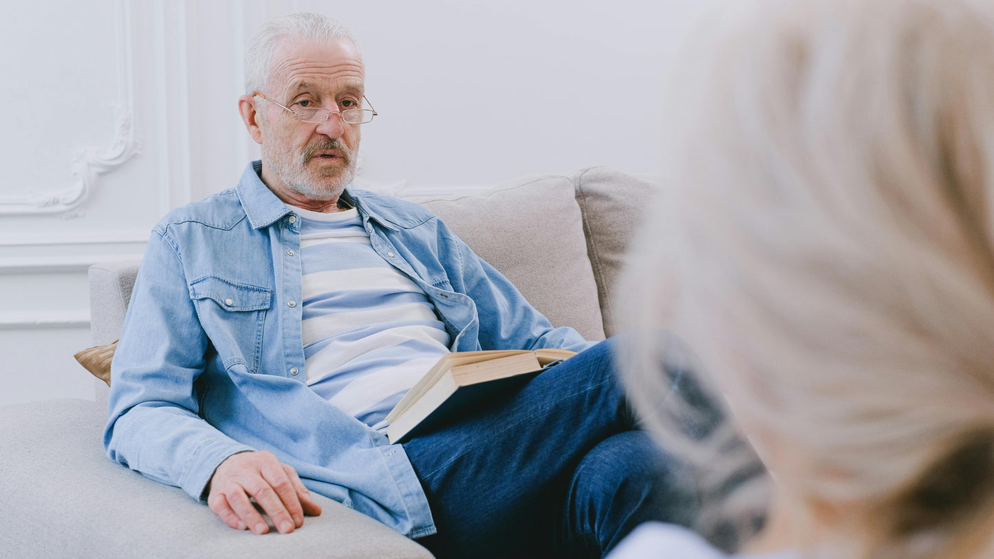 An elderly man sharing his life story in a quiet conversation at home
